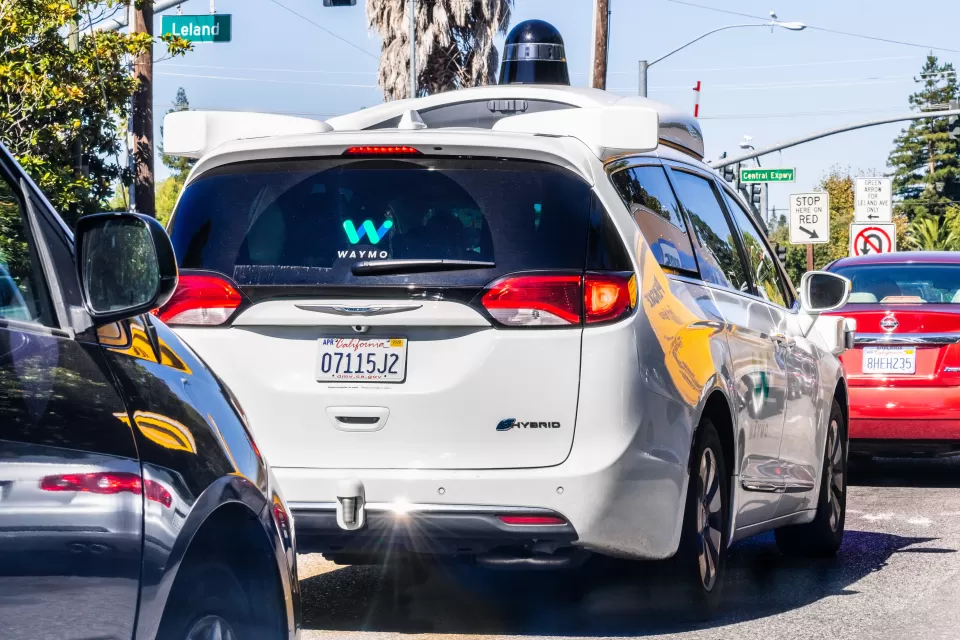 White Waymo self-driving minivan taxi on street Mountain View, California